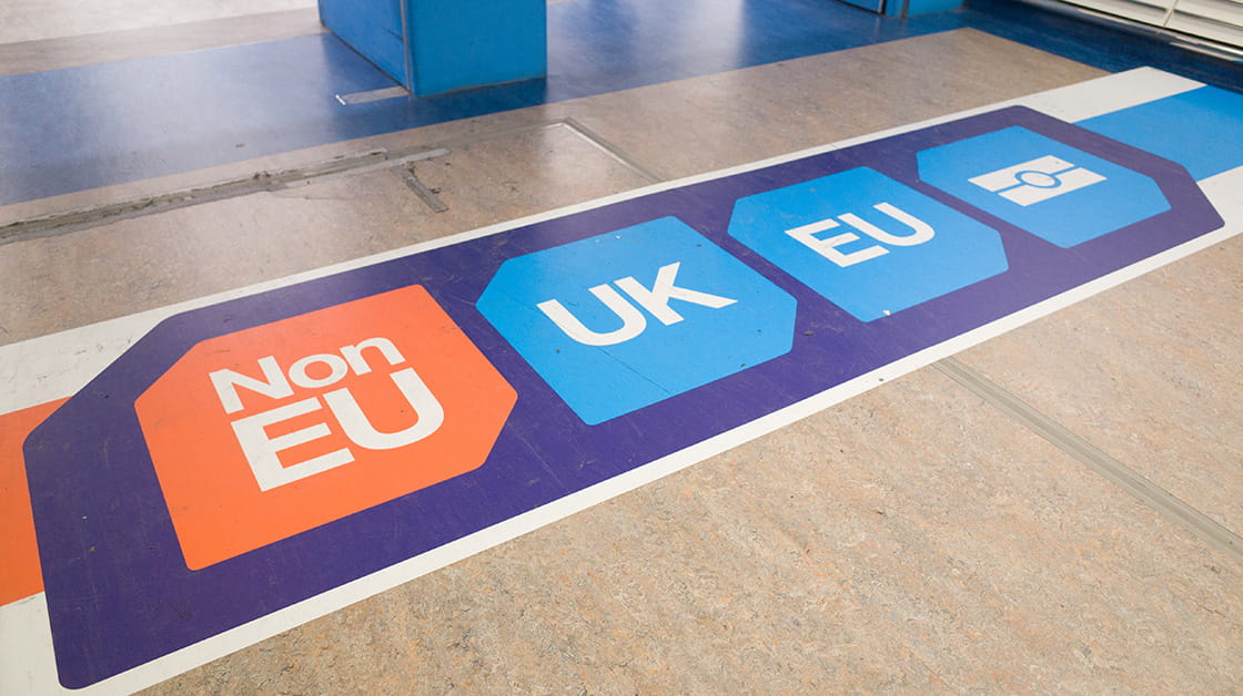 Passport control signage on the floor at Gatwick Airport directs passengers to 'non EU', 'UK' and 'EU' passport control points. (Crawley, England - December 2, 2016)