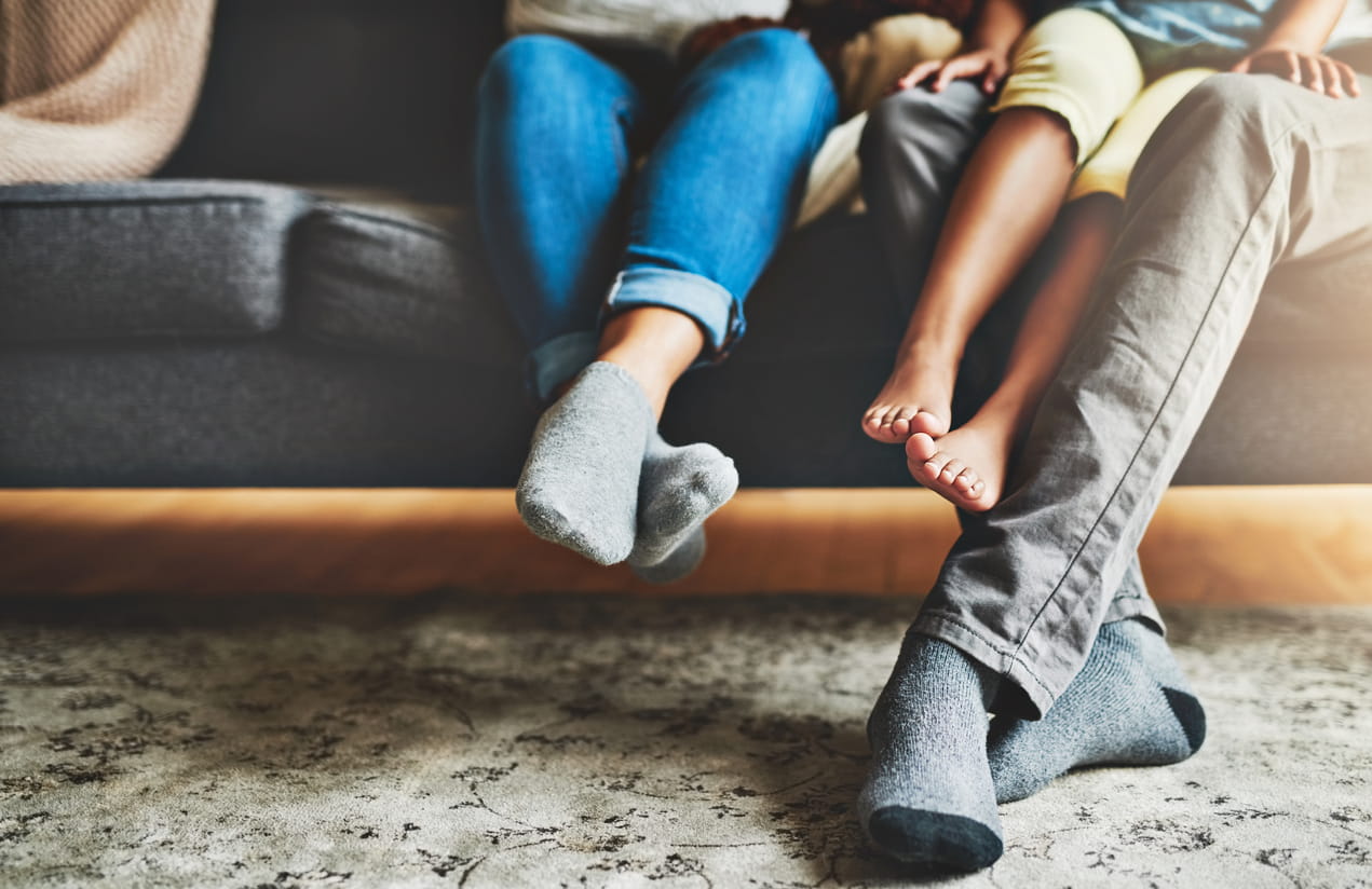 Family-sitting-together-on-a-couch-feet-dangling