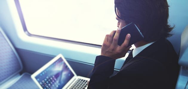 Man on train with laptop