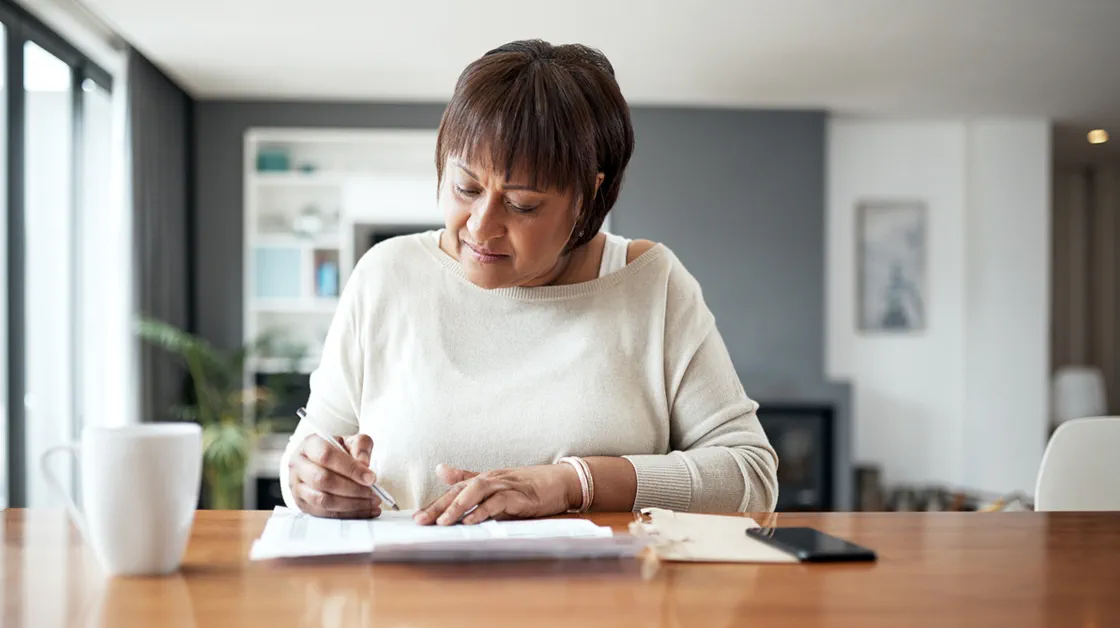 Person at table writing