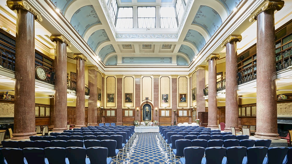 The Reading Room of European Union is a large, grand room with a high, vaulted ceiling with a gilded wooden gallery and leather-bound books.