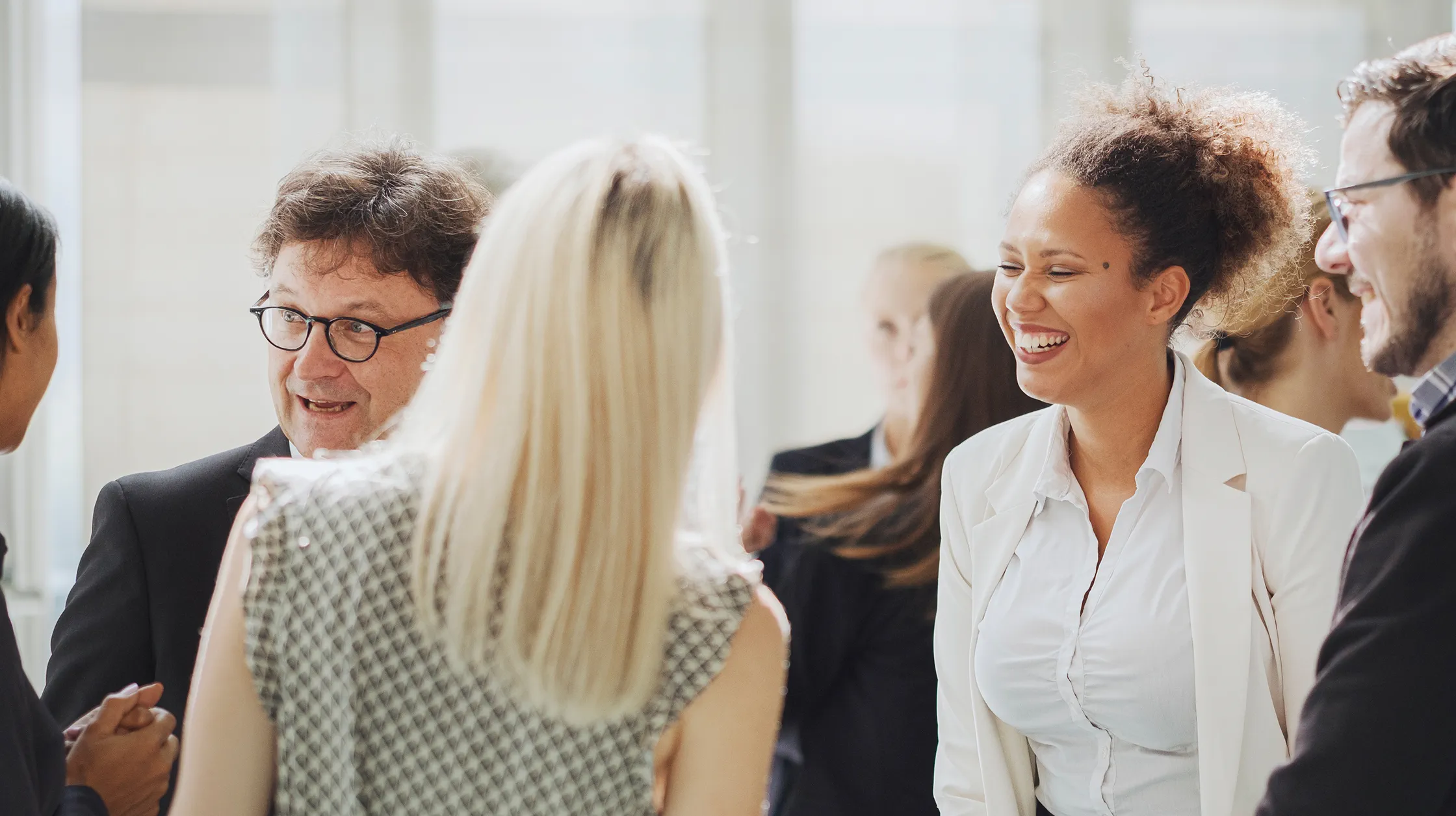 Smiling, laughing group of colleagues at networking event