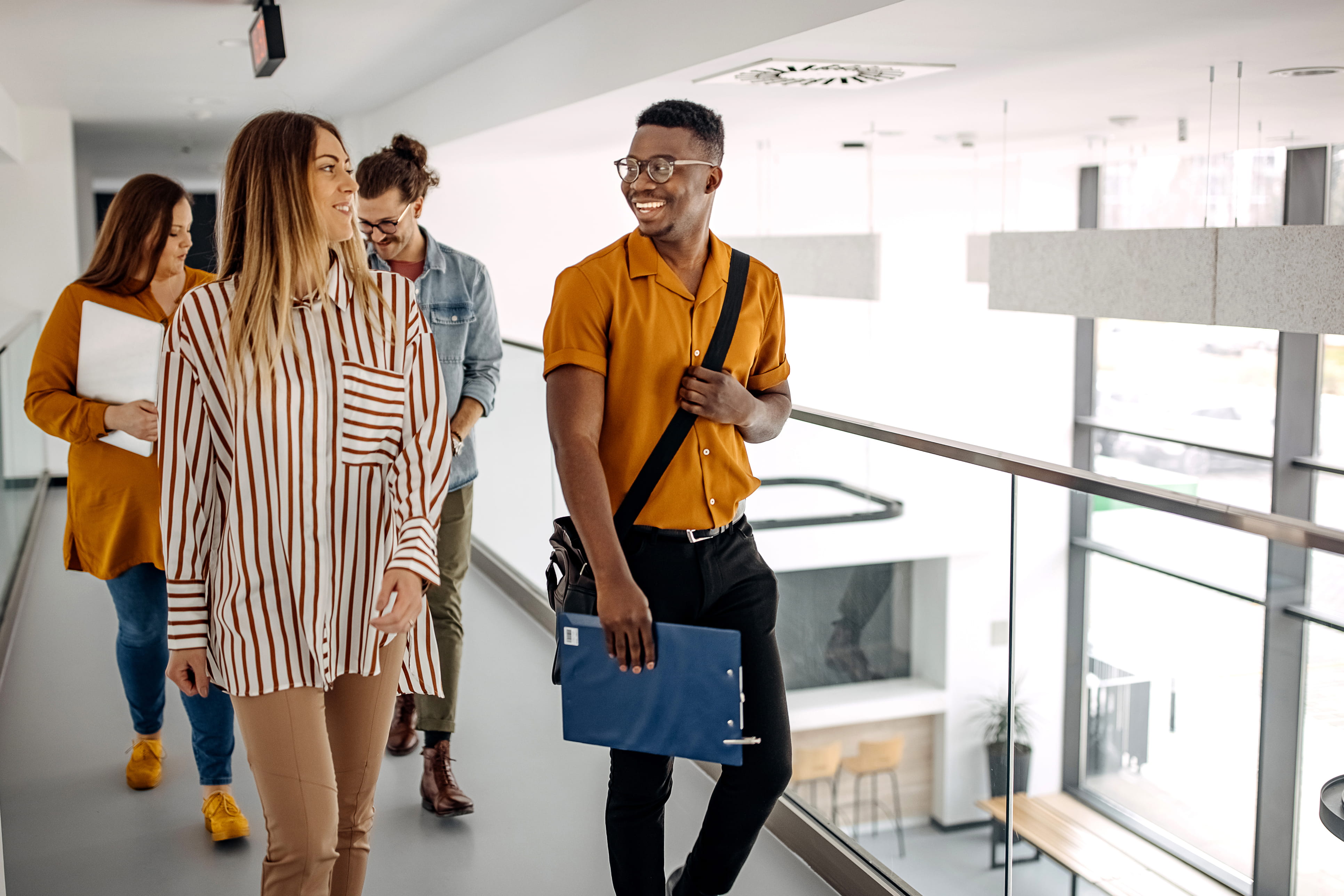 four-students-walking-in-an-office-environment