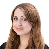 Tamsyn Hyatt is a white woman with brown hair and blue eyes, smiling in a professional headshot with a white background