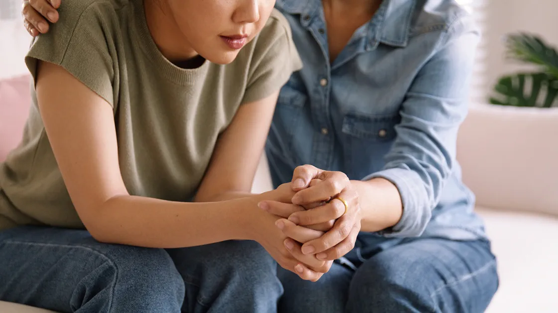 A woman supports a child