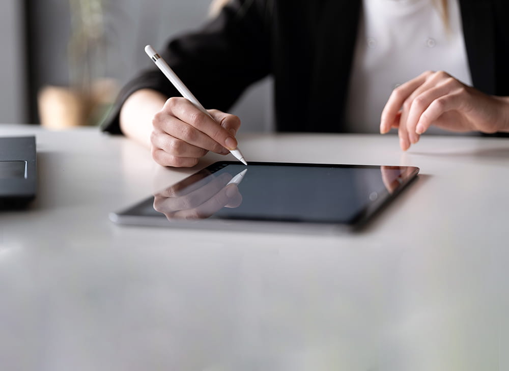 Woman signing electronic document using tablet