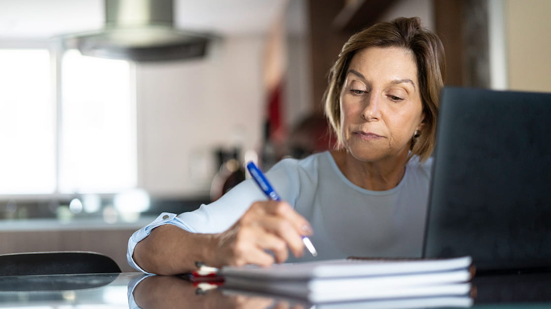 Woman writing a will at home